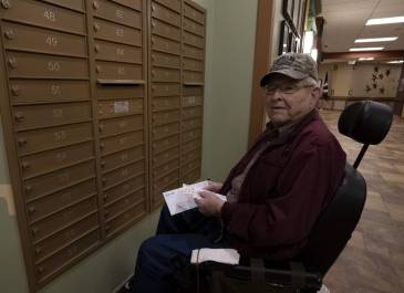 A resident of the North Dakota Veterans Home checking his mail in the mail area.