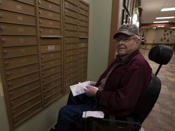 A resident of the North Dakota Veterans Home checking his mail in the mail area.