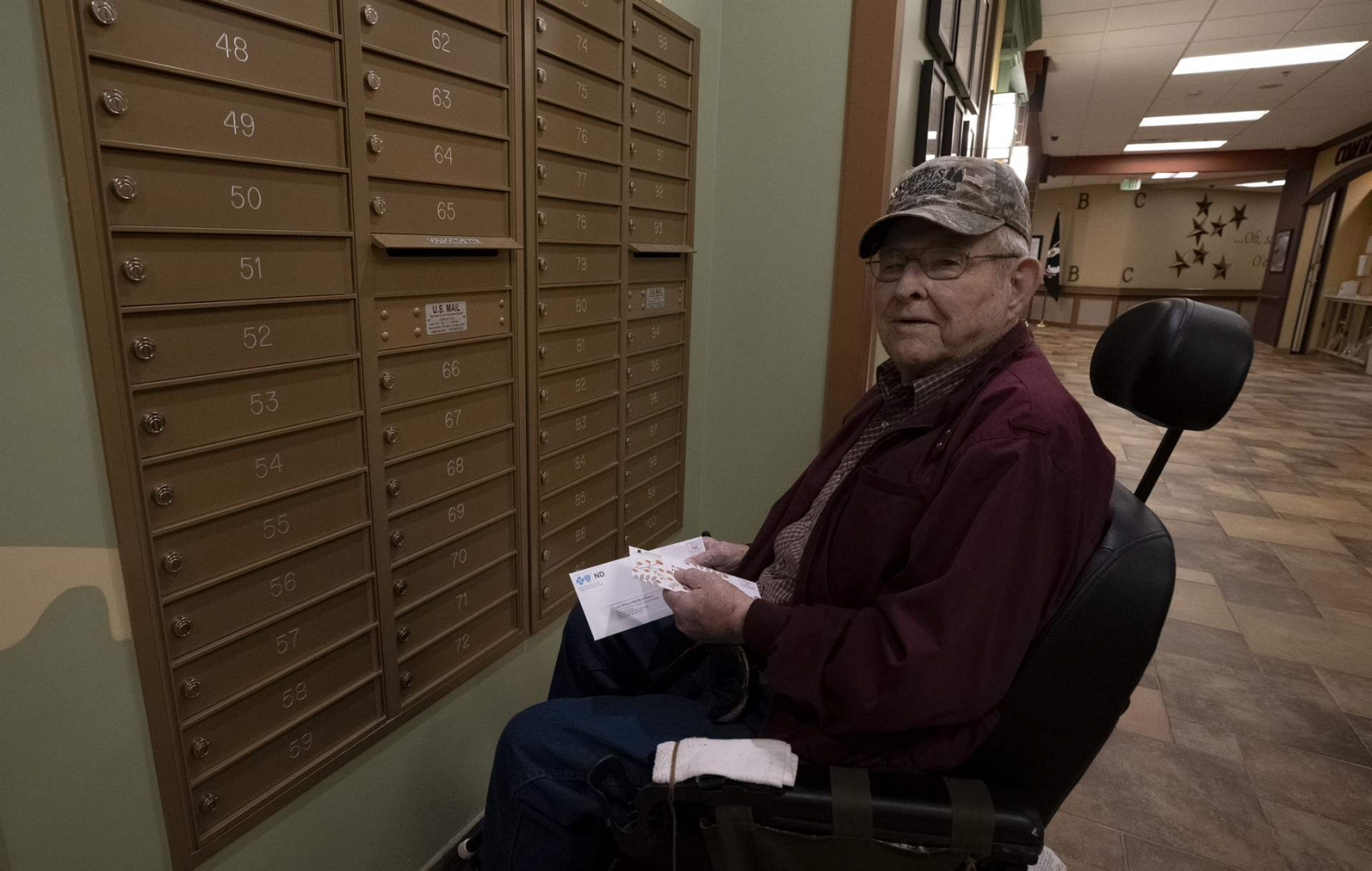 A resident of the North Dakota Veterans Home checking his mail in the mail area.